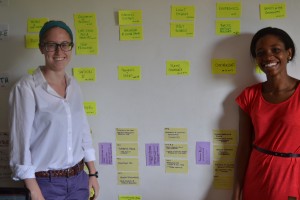 Interns Ellie Sell and Ada Oambi use sticky notes to plan out their public health curriculum