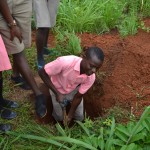 Students dig a hole for the compost